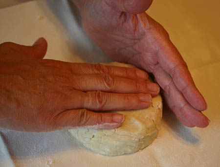 Press dough with both hands to smooth edges.